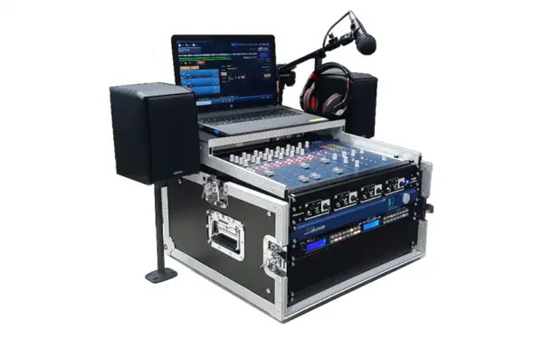 AEV Outside Flightcase portable radio studio with BSM Evolution console, rack electronics, laptop with automation software, microphones, headphones and compact active monitors in a rugged flightcase.