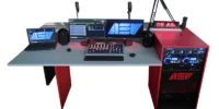 AEV SMART compact radio studio package with red on‑air desk, broadcast console, dual monitors, microphones, laptop, rack equipment and illuminated On Air sign.