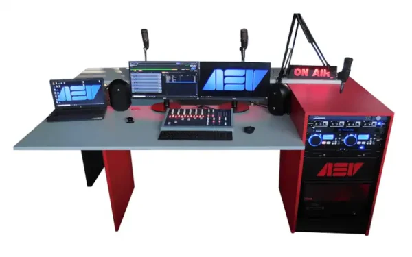 AEV SMART compact radio studio package with red on‑air desk, broadcast console, dual monitors, microphones, laptop, rack equipment and illuminated On Air sign.